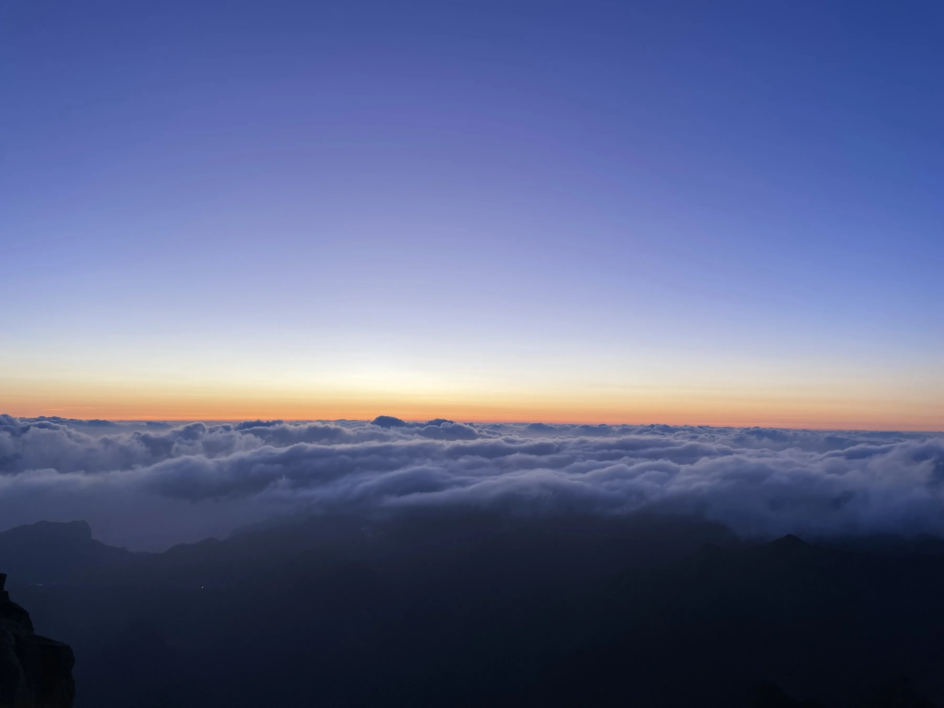 Dawn above a sea of cloud from a mountain top