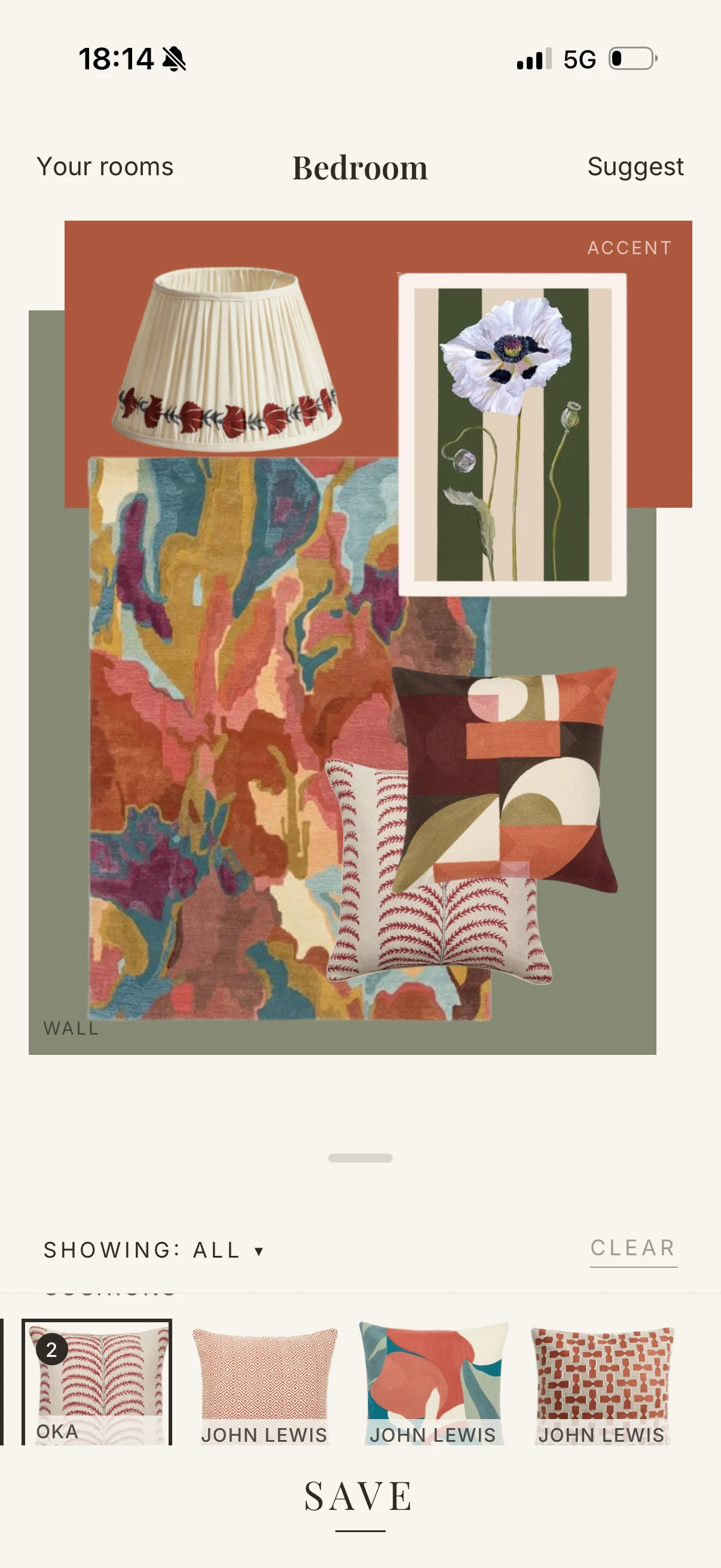 A Fold Studios scheme board: a rug, a lamp, a print and two cushions over a sage wall and a terracotta accent
